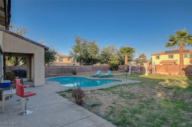 view of pool featuring a lawn and a patio area