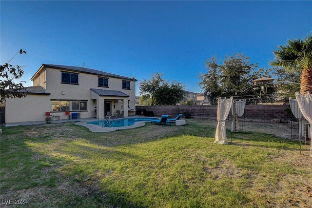 exterior space featuring a fenced in pool and a yard