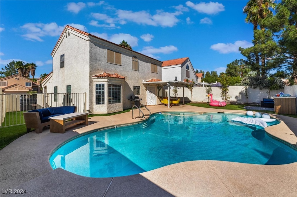 view of pool featuring a grill and a patio