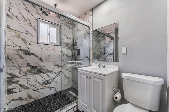 bathroom with vanity, toilet, and a shower with door