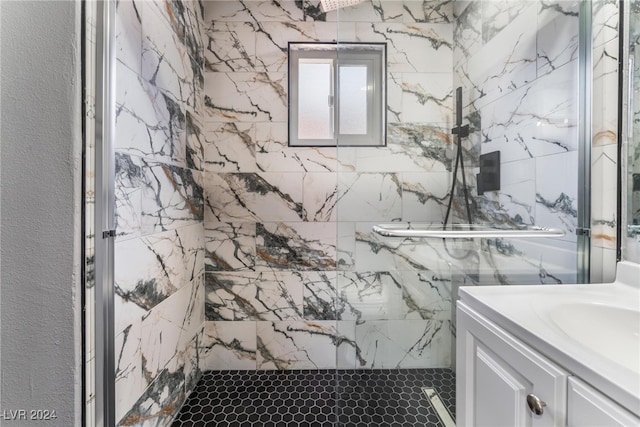 bathroom with vanity and a tile shower