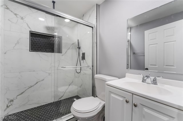 bathroom featuring walk in shower, vanity, and toilet