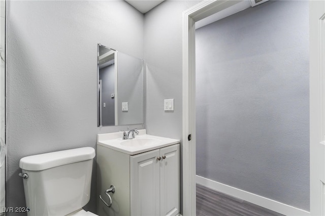 bathroom featuring hardwood / wood-style floors, vanity, and toilet