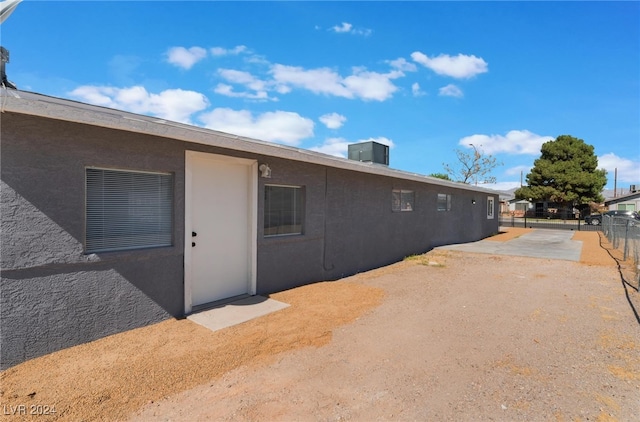 view of side of property featuring central AC