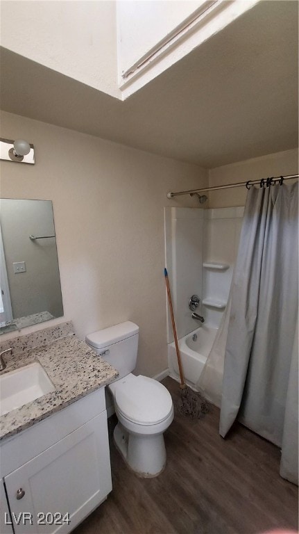 full bathroom featuring hardwood / wood-style flooring, toilet, shower / bath combination with curtain, vanity, and a skylight