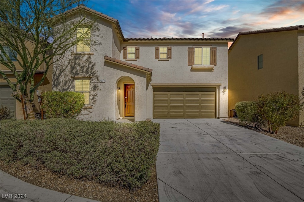 mediterranean / spanish-style house featuring a garage