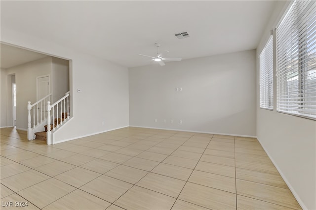 spare room featuring light tile patterned floors and ceiling fan