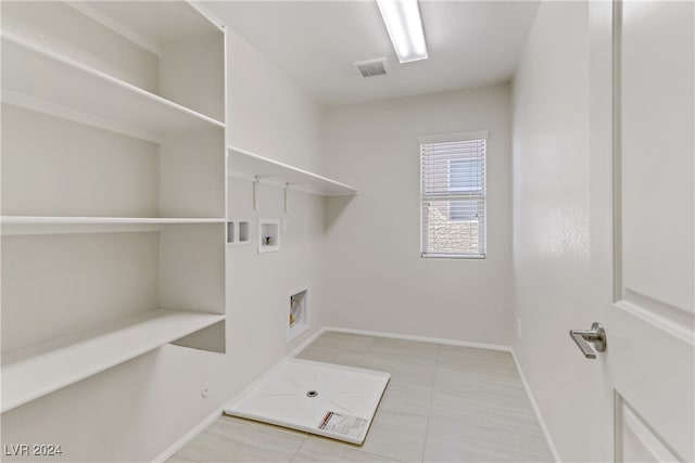 clothes washing area with gas dryer hookup, light tile patterned flooring, and washer hookup