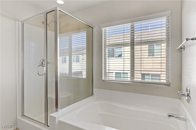 bathroom with shower with separate bathtub