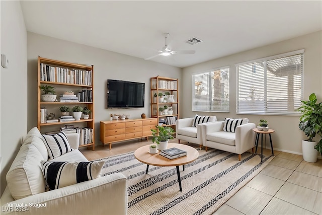 tiled living room with ceiling fan