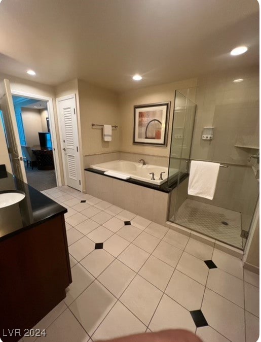 bathroom with separate shower and tub, tile patterned floors, and vanity