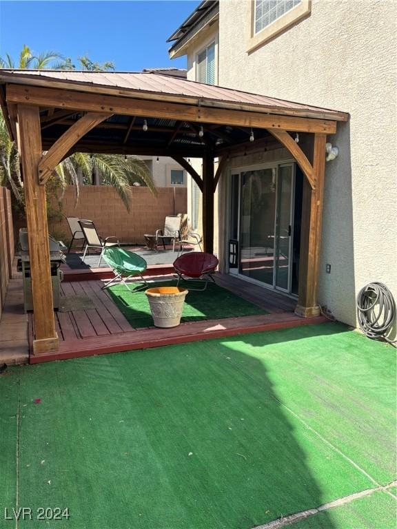 exterior space with a gazebo, fence, and a wooden deck