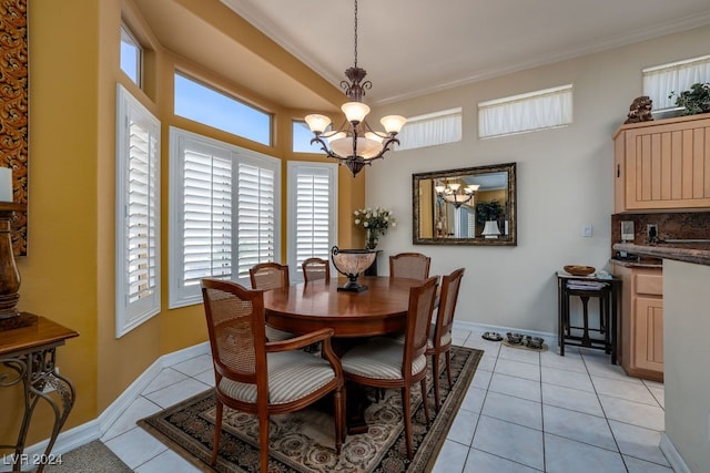 tiled dining room with an inviting chandelier and crown molding