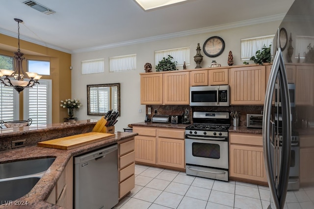 kitchen featuring appliances with stainless steel finishes, decorative backsplash, and light brown cabinets