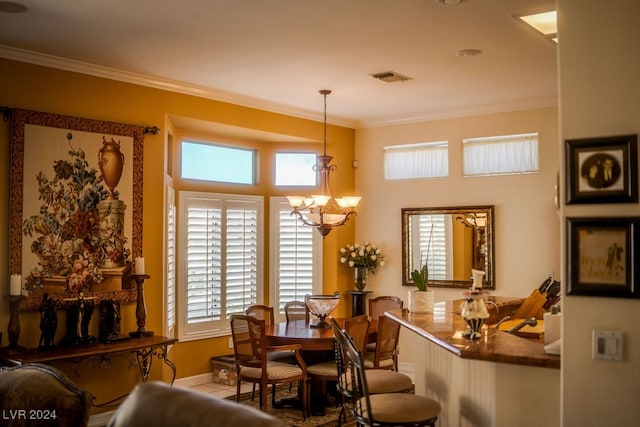 dining area featuring crown molding and an inviting chandelier