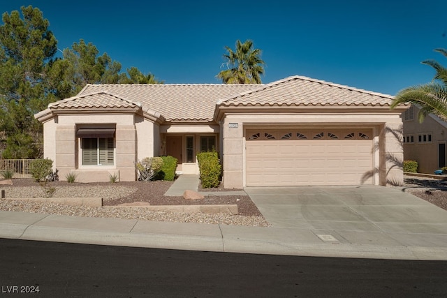 mediterranean / spanish house featuring a garage