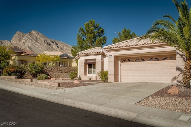 mediterranean / spanish-style house featuring a mountain view and a garage