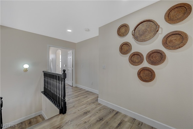 stairs with hardwood / wood-style floors