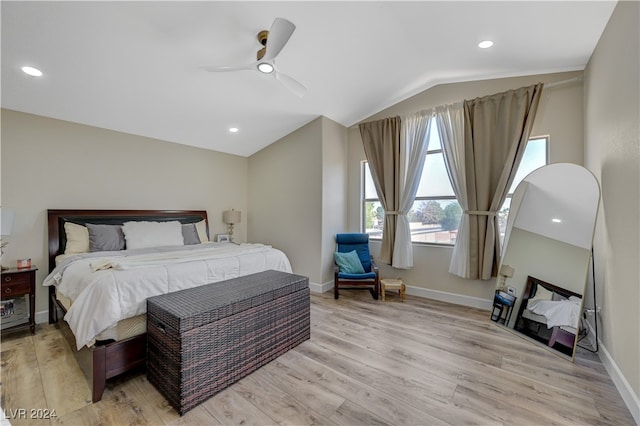 bedroom featuring ceiling fan, lofted ceiling, and light wood-type flooring