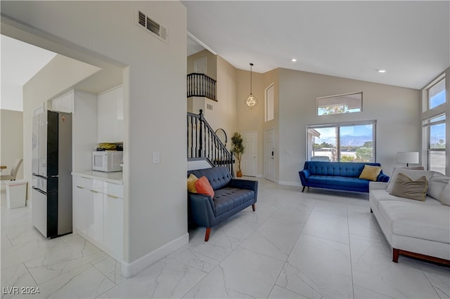 living room with high vaulted ceiling and a wealth of natural light