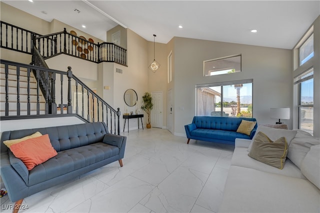 living room featuring high vaulted ceiling and plenty of natural light