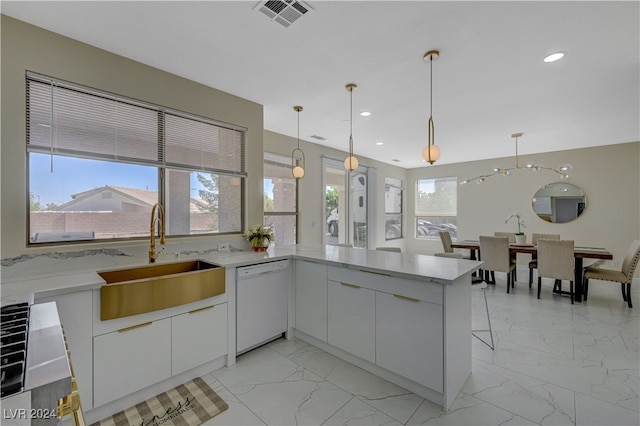 kitchen featuring kitchen peninsula, white cabinetry, dishwasher, decorative light fixtures, and sink