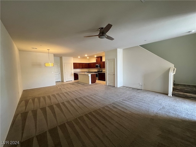 unfurnished living room with ceiling fan and carpet flooring