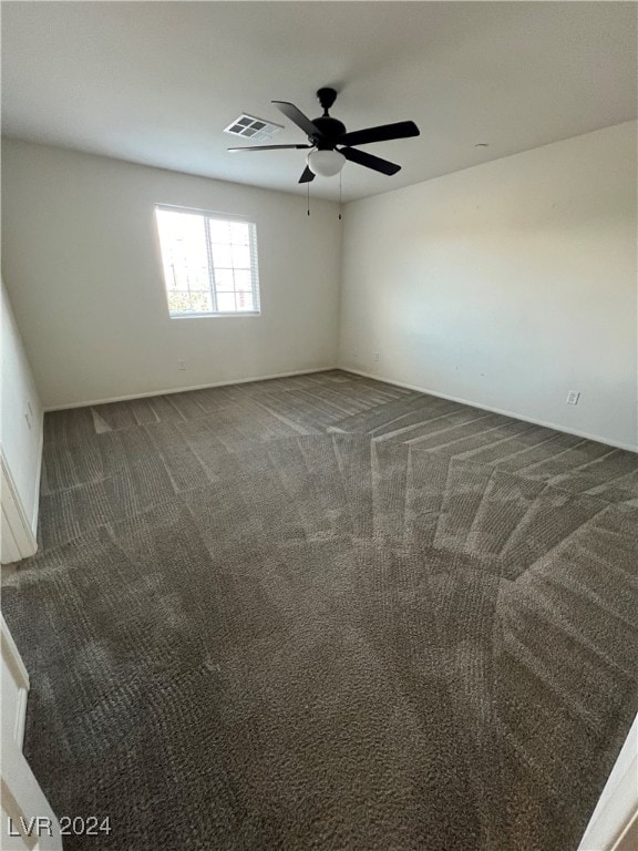 carpeted empty room featuring ceiling fan