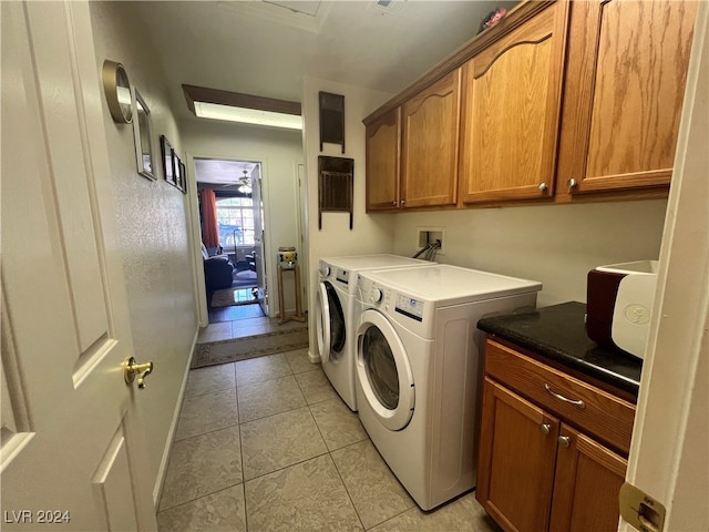 clothes washing area featuring cabinets, separate washer and dryer, light tile patterned floors, and ceiling fan