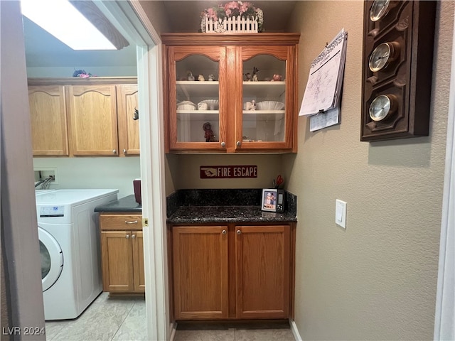 laundry area with cabinets and washer / dryer