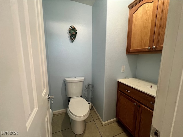 bathroom with vanity, tile patterned floors, and toilet