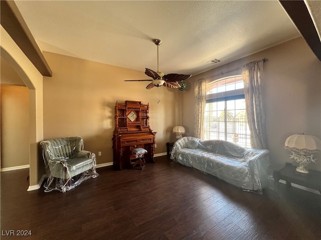 sitting room featuring a textured ceiling, dark hardwood / wood-style floors, and ceiling fan