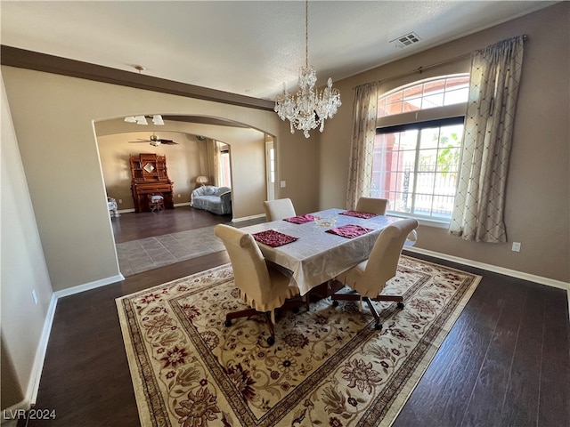 dining area with dark hardwood / wood-style floors and an inviting chandelier