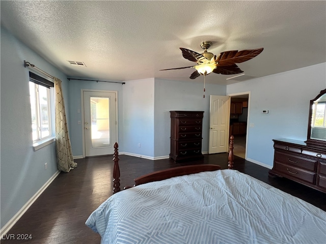 bedroom with dark hardwood / wood-style flooring, a textured ceiling, and ceiling fan