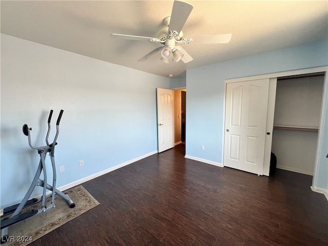 unfurnished bedroom with ceiling fan, dark hardwood / wood-style floors, and a closet