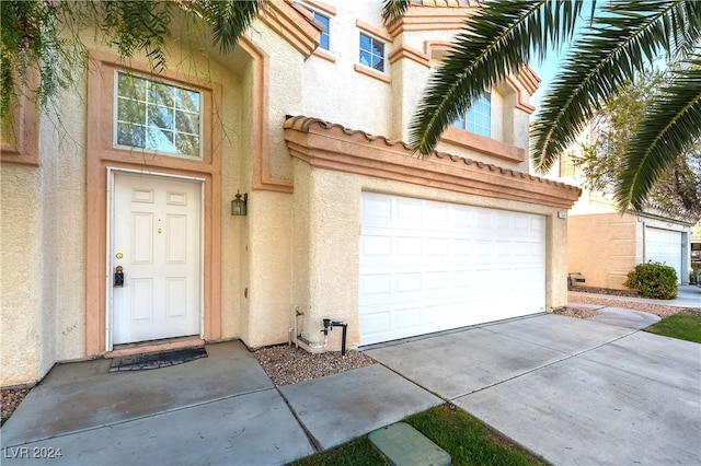 view of exterior entry featuring a garage