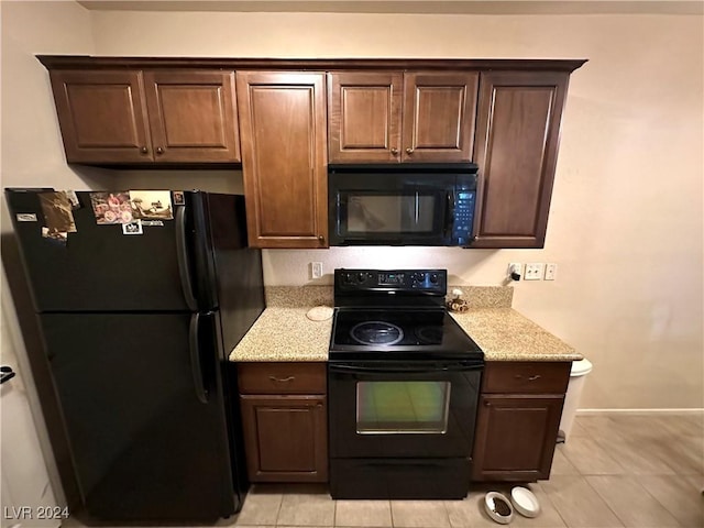 3550 Bay Sands Dr Unit 1085, Laughlin, NV 89029 - kitchen with black appliances, light tile patterned floors, light stone counters, and dark brown cabinetry