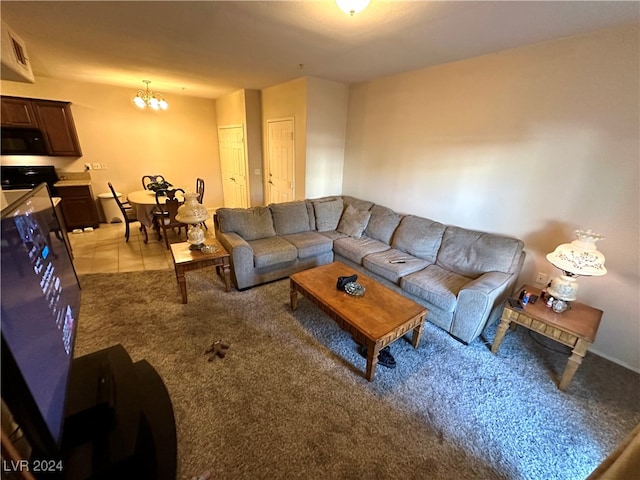 carpeted living room with an inviting chandelier