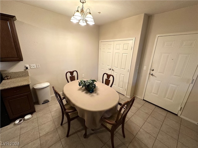 dining area featuring a chandelier and light tile patterned floors