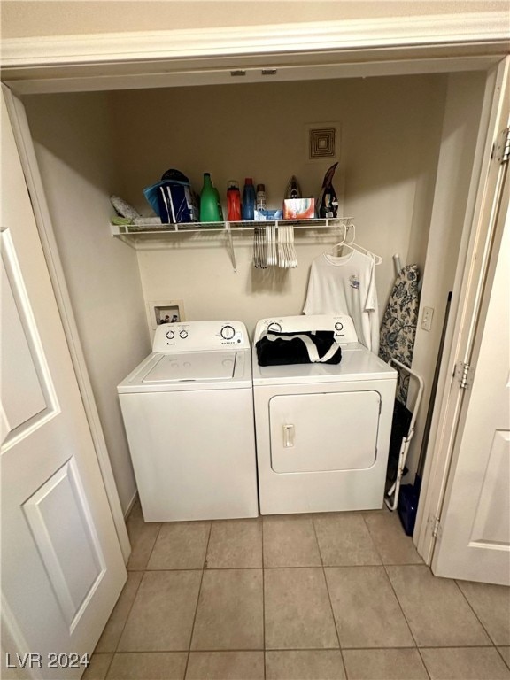 laundry area featuring separate washer and dryer and light tile patterned floors