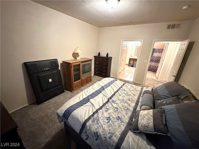 carpeted bedroom with ensuite bathroom