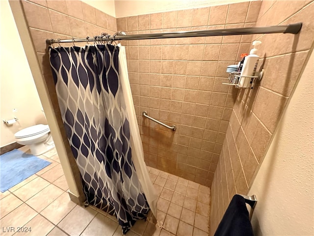 bathroom featuring walk in shower, tile patterned flooring, and toilet