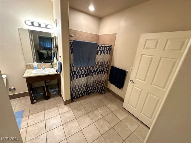 bathroom featuring tile patterned floors, walk in shower, and vanity