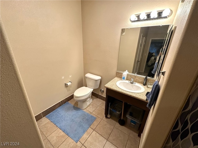 bathroom featuring tile patterned floors, vanity, and toilet