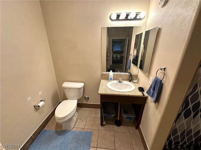 bathroom featuring tile patterned floors, vanity, and toilet