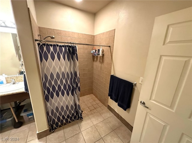 bathroom with tile patterned flooring, sink, and a shower with shower curtain