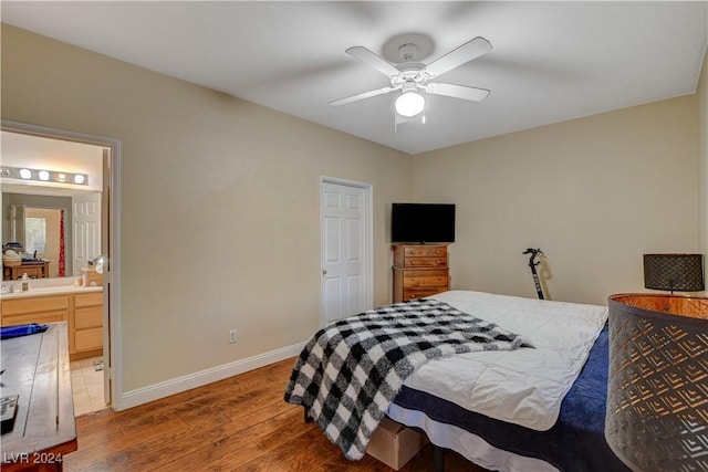 bedroom with ceiling fan, dark wood-type flooring, and ensuite bathroom