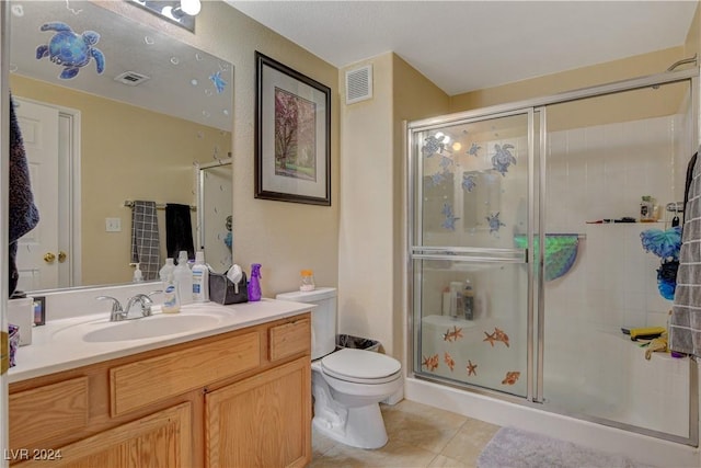 bathroom featuring vanity, an enclosed shower, tile patterned flooring, and toilet