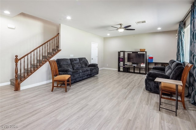 living room featuring ceiling fan and light hardwood / wood-style flooring