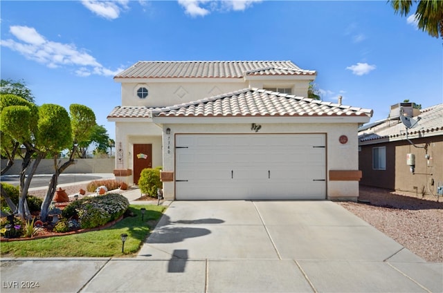 mediterranean / spanish-style home with a garage